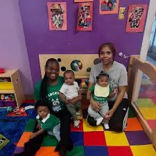 Caregivers with infants in the nursery