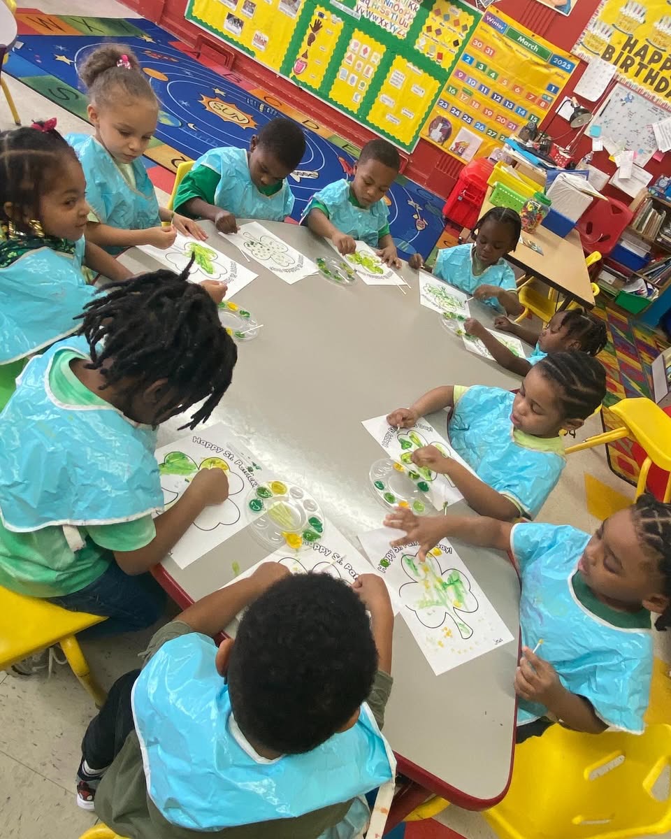 Children painting at a craft table