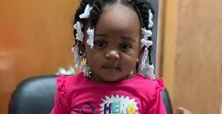 A happy toddler with hair bows