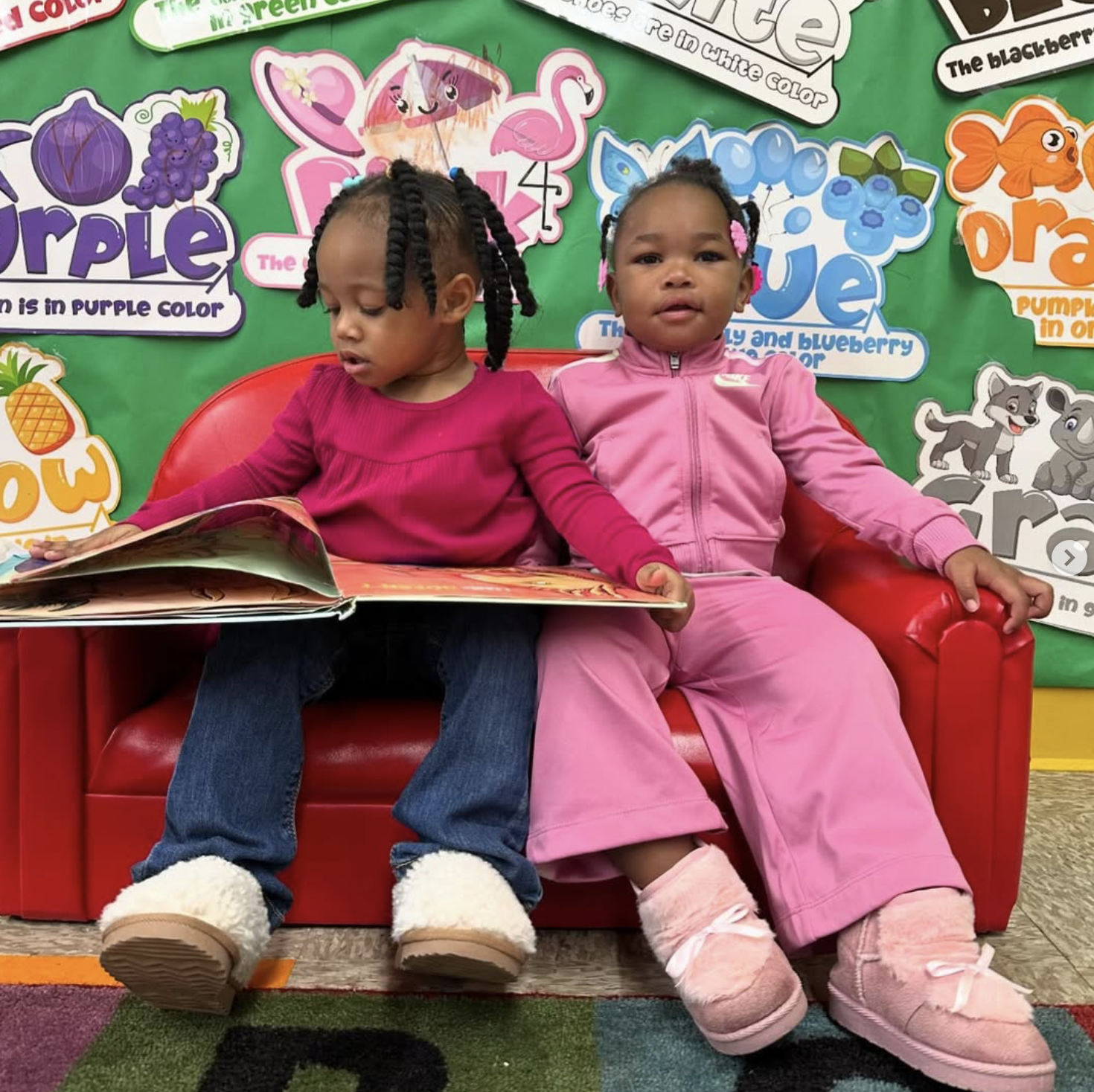 Two girls reading a picture book together